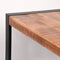 Table à manger industrielle 160 cm avec plateau en bois brut.